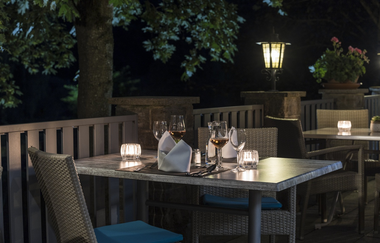 Außenterrasse am Abend mit Kerzen auf den Tischen | © Touristikgemeinschaft Hohenlohe e. V. | Die Krone am Fluss