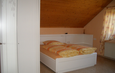 Schlafzimmer mit Doppelbett, orangefarben eingerichtet | © Neckar-Zaber-Tourismus e.V.