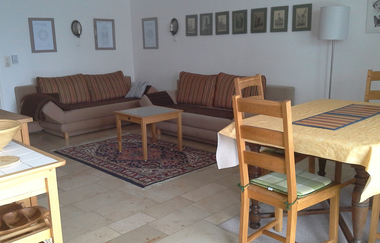 Im Wohnraum gibt es eine Schlafcouch und einen Tisch mit vier Stühlen. | © Touristikgemeinschaft Hohenlohe e. V.  | Ferienwohnung Jagstblick