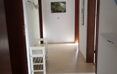 Flur mit vier Türen und einem kleinen niedrigen Schuhschrank