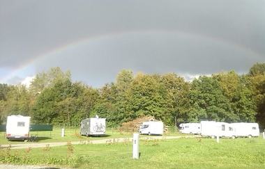 Begrünter Campingplatz mit Wohnmobilen und Regenbogen am Himmel | © Gemeinde Schwarzach