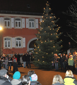 Menschen beim Singen auf dem beleuchteten Marktplatz