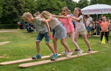 Spielstation, Gruppe von Kindern läuft gemeinsam mit einem großen Paar Ski | © Heilbronn Marketing GmbH