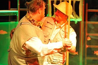 Zwei Schauspieler stellen eine Szene dar, Bär und Zoodirektor tanzen.