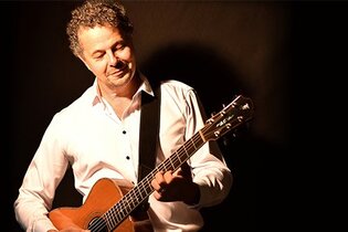 Der Künstler Jürgen Ferber mit seiner Gitarre.