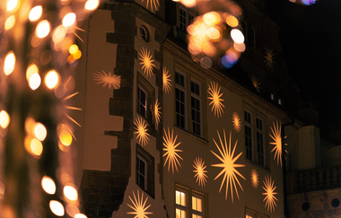 An eine Fassade projezierte Sterne | © Touristikgemeinschaft Hohenlohe e. V. | Stadt Öhringen