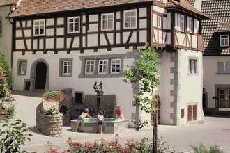 Fachwerkfassade mit Brunnen, in dem sich das Museum befindet | © Touristikgemeinschaft Hohenlohe e. V. | Eva Maria Kraiss