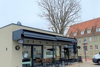 Außenansicht und Plätze vor dem Café