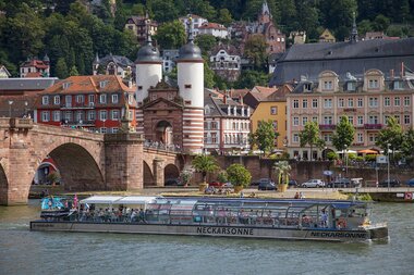 Solarschiff auf dem Neckar mit der Alten Brücke und Altstadt im Hintergrund | © Heidelberg Marketing GmbH / Mende