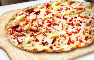 Klassicher Flammkuchen auf einem Holzbrett | © Wagnerhaus Café Maulbronn