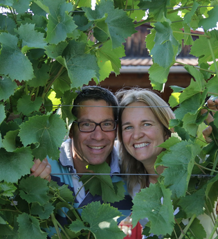 Freundliche Begrüßung der Familie Haeussermann mit Blick durch die Reben | © Weingut Haeussermann