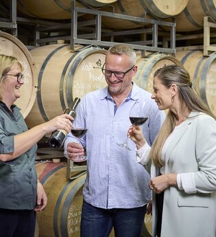 Regina Birkert lässt ein Paar Wein im Keller probieren | © Touristikgemeinschaft Hohenlohe e.V. | Andi Schmid