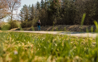 Eine junge Frau wandert auf einem befestigten Weg | © Stadtverwaltung Crailsheim
