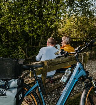 Zwei Radfahrer machen eine Pause auf einer Bank am Kneippbecken | © Stadtverwaltung Crailsheim
