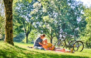 Radfahrer machen Picknick auf der Wiese | © Touristikgemeinschaft Hohenlohe e. V. | Florian Trykowski
