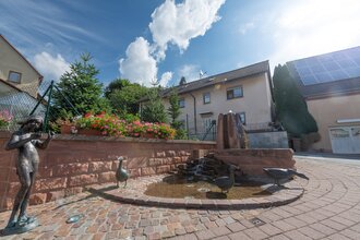 Steinerner Brunnen mit Gänsen und Figuren an einem gepflasterten Platz | © Stadt Sinsheim